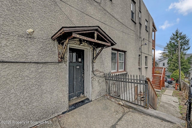 401-405 S Main Ave, Scranton, PA 18504 - doorway to property with fence and stucco siding