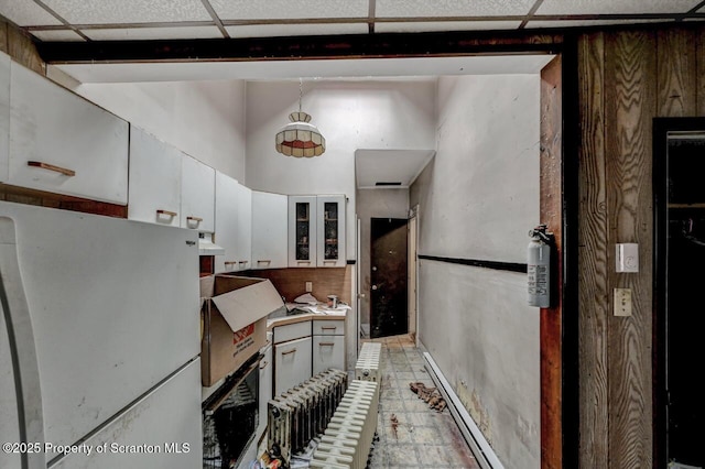 401-405 S Main Ave, Scranton, PA 18504 - kitchen featuring freestanding refrigerator, white cabinets, glass insert cabinets, and light countertops