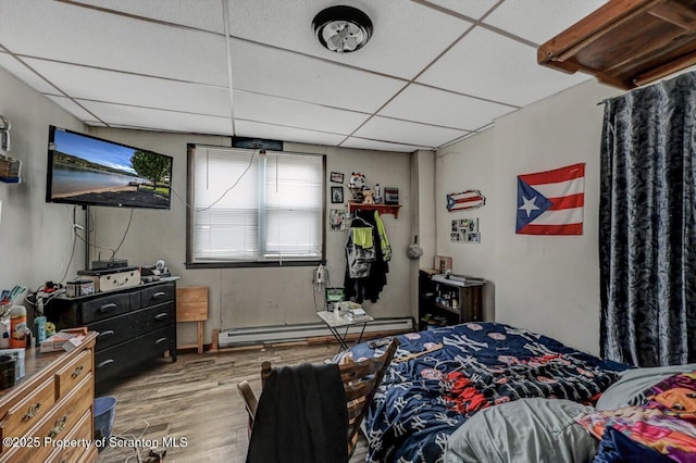 401-405 S Main Ave, Scranton, PA 18504 - bedroom featuring wood finished floors, a drop ceiling, and a baseboard heating unit