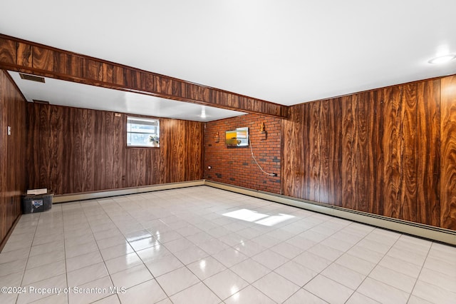 empty room featuring wooden walls, light tile patterned flooring, and brick wall