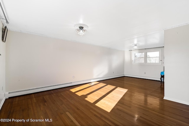 unfurnished room featuring dark hardwood / wood-style flooring, an inviting chandelier, and baseboard heating