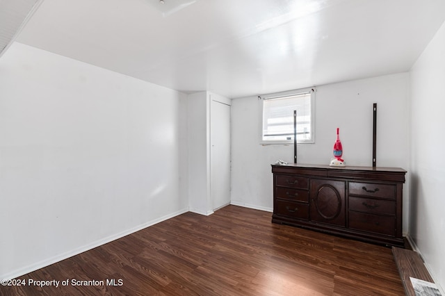 unfurnished bedroom featuring dark hardwood / wood-style floors