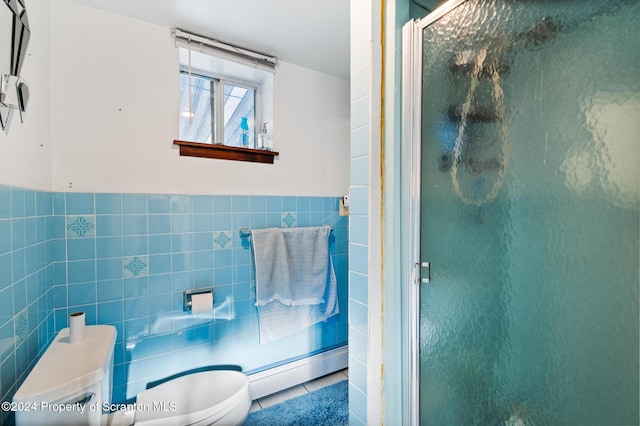 bathroom featuring baseboard heating, tile walls, tile patterned flooring, and an enclosed shower