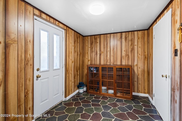 entryway featuring wooden walls