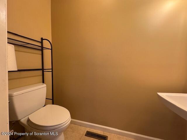 bathroom featuring tile patterned floors and toilet