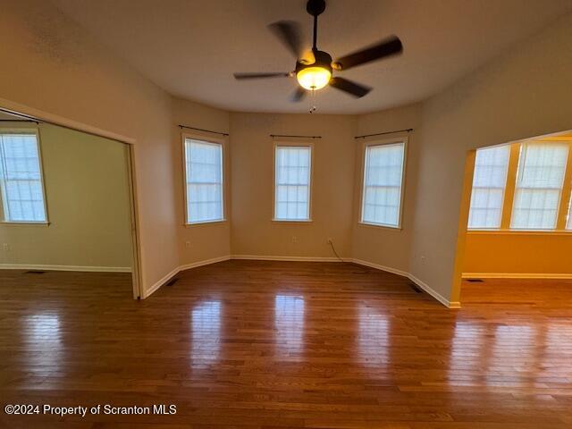 empty room featuring ceiling fan and dark hardwood / wood-style floors