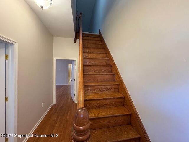 stairway with hardwood / wood-style flooring