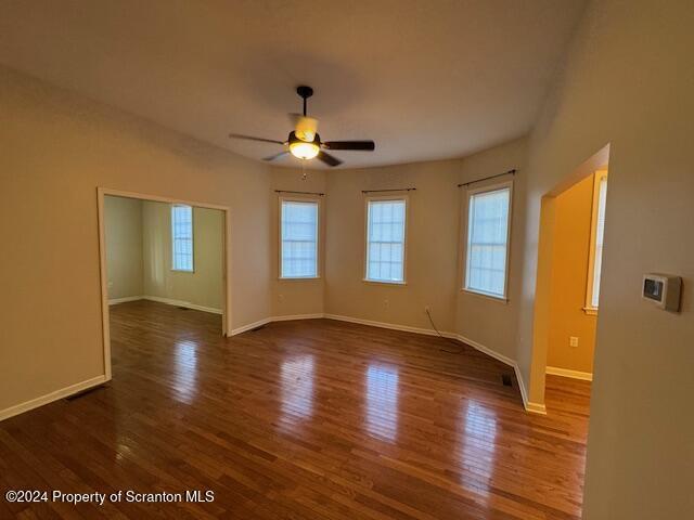 empty room featuring ceiling fan and dark hardwood / wood-style floors