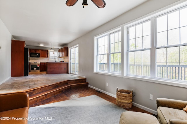 interior space featuring ceiling fan, plenty of natural light, and hardwood / wood-style floors