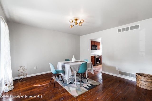 dining room with a notable chandelier and dark hardwood / wood-style floors