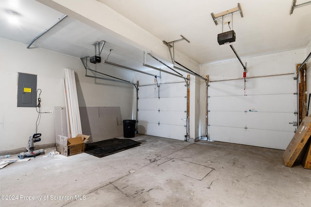 garage with electric panel and a garage door opener