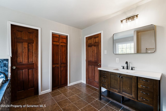 bathroom featuring vanity and a bath