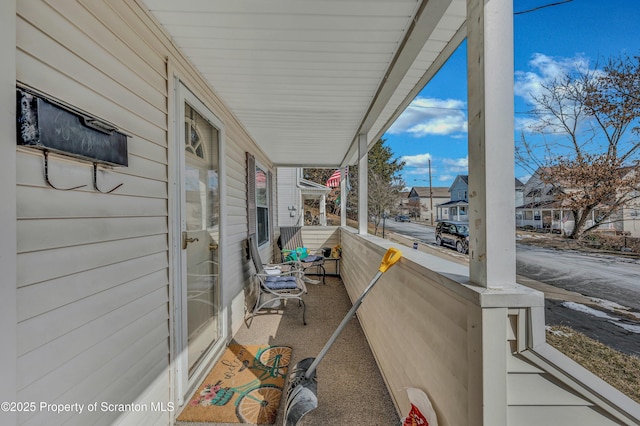 view of patio with covered porch and a residential view