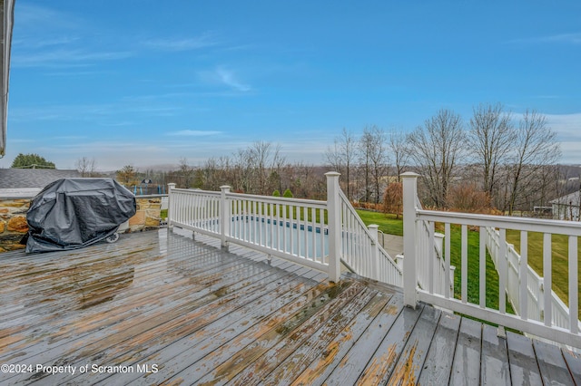 wooden deck featuring a yard and area for grilling