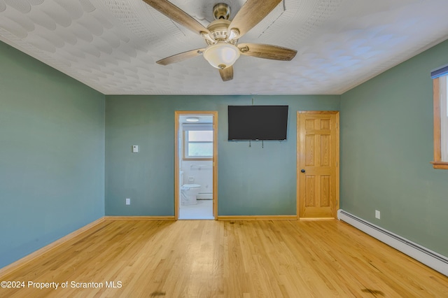 spare room with a baseboard radiator, ceiling fan, and light hardwood / wood-style floors