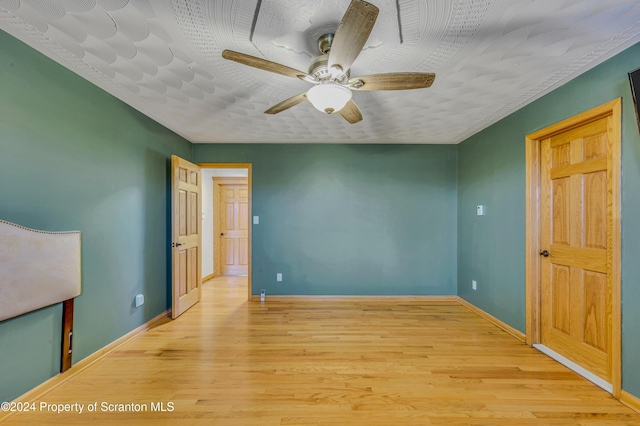 unfurnished bedroom with ceiling fan and light hardwood / wood-style floors