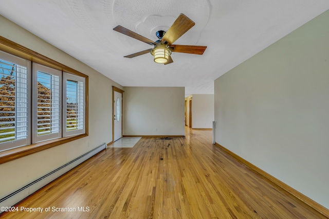 unfurnished room with ceiling fan, light hardwood / wood-style flooring, and a baseboard radiator