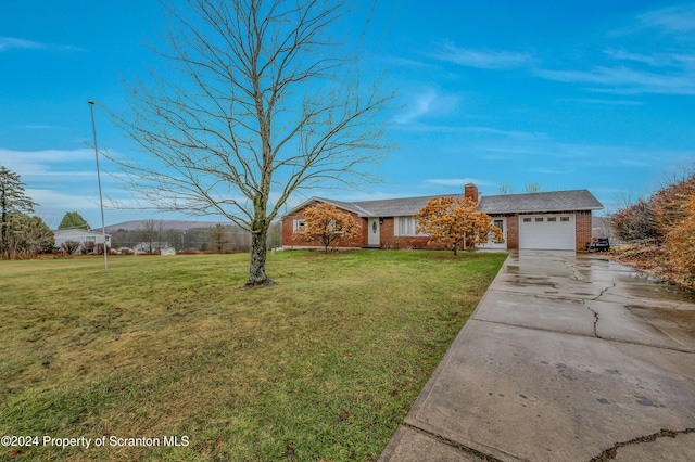 ranch-style home with a front lawn and a garage