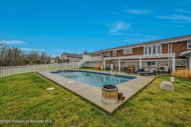 view of swimming pool featuring a lawn, ac unit, and a pergola