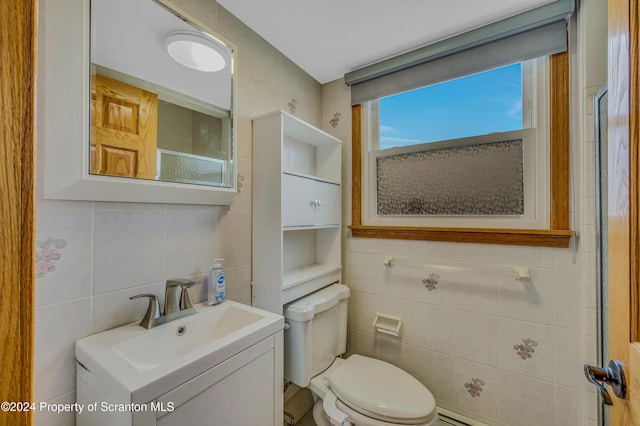 bathroom featuring vanity, toilet, tile walls, and tasteful backsplash