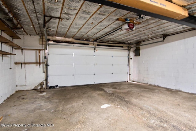 206 Florence Dr, Clarks Summit, PA 18411 - garage featuring a garage door opener and concrete block wall