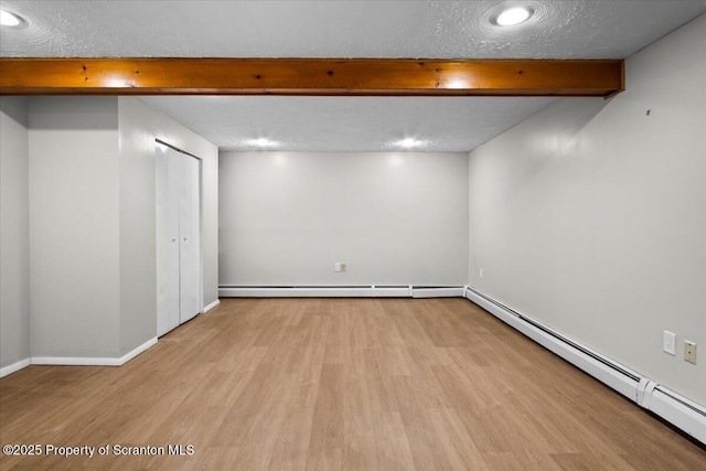 206 Florence Dr, Clarks Summit, PA 18411 - below grade area with baseboard heating, light wood-style flooring, a textured ceiling, and recessed lighting