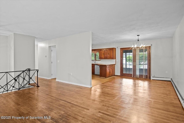 206 Florence Dr, Clarks Summit, PA 18411 - empty room with a chandelier, light wood-type flooring, and a baseboard heating unit