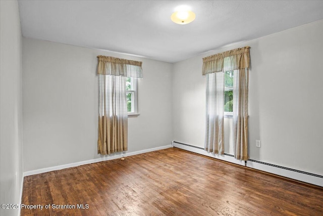 206 Florence Dr, Clarks Summit, PA 18411 - spare room with baseboard heating, plenty of natural light, and wood finished floors