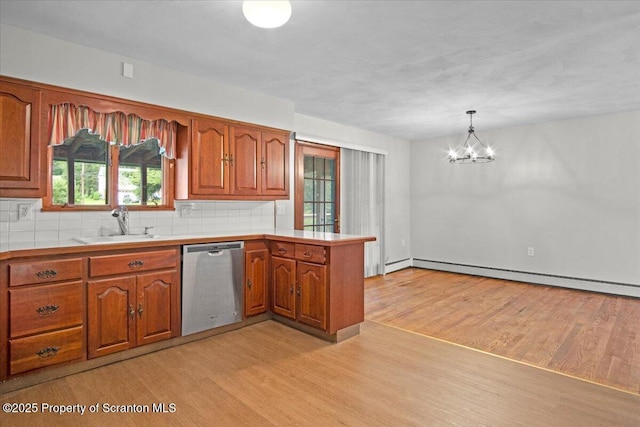 206 Florence Dr, Clarks Summit, PA 18411 - kitchen featuring dishwasher, a peninsula, a baseboard heating unit, light wood-style floors, and brown cabinets