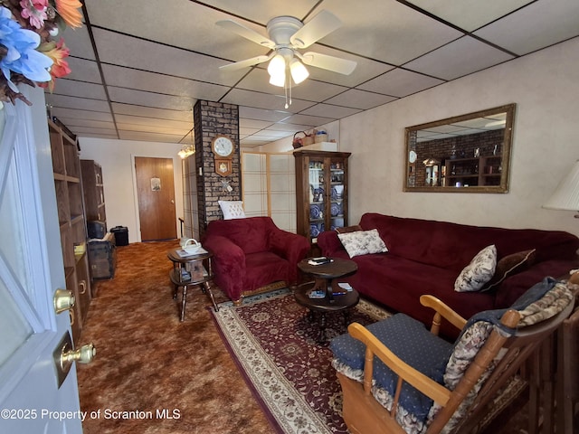 carpeted living room with a paneled ceiling and ceiling fan