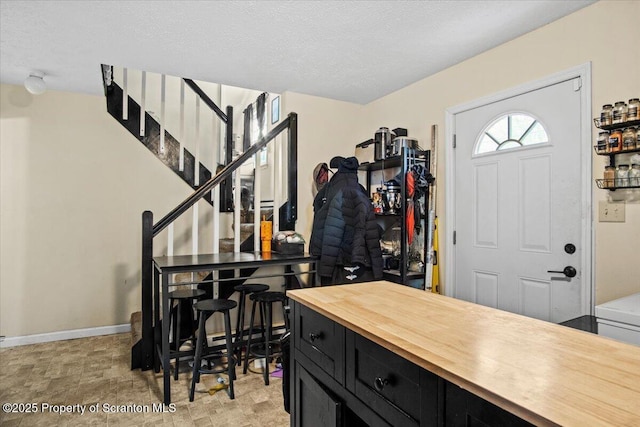 entryway featuring a textured ceiling