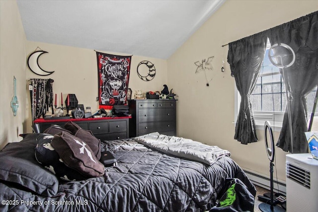 bedroom featuring baseboard heating and lofted ceiling