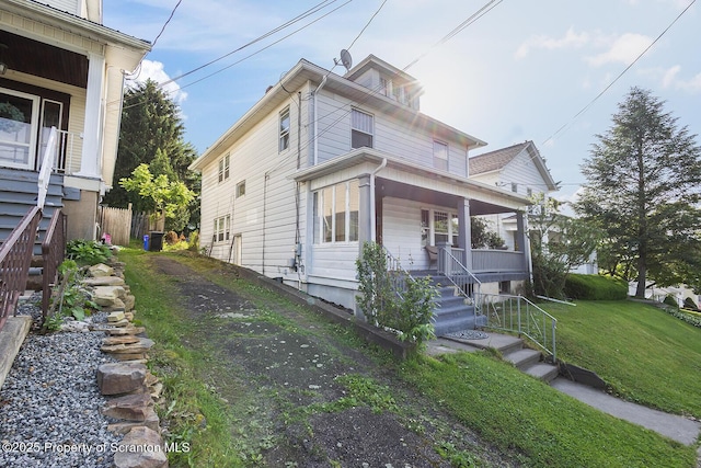 818 Cherry St, Scranton, PA 18505 - view of front facade with covered porch, a front yard, and stairway