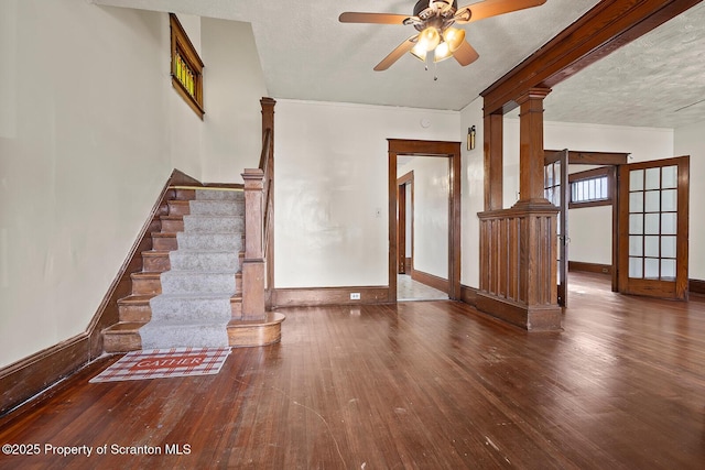 818 Cherry St, Scranton, PA 18505 - unfurnished living room featuring stairs, wood-type flooring, ceiling fan, ornate columns, and a textured ceiling