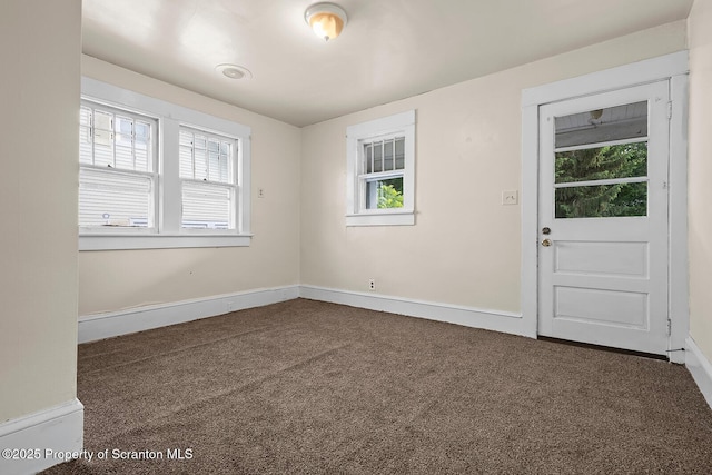 818 Cherry St, Scranton, PA 18505 - spare room featuring dark colored carpet and plenty of natural light