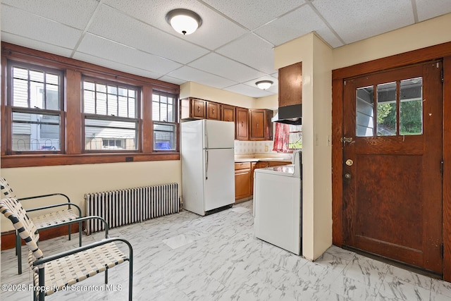 818 Cherry St, Scranton, PA 18505 - kitchen featuring freestanding refrigerator, radiator heating unit, a paneled ceiling, washer / clothes dryer, and wall chimney exhaust hood