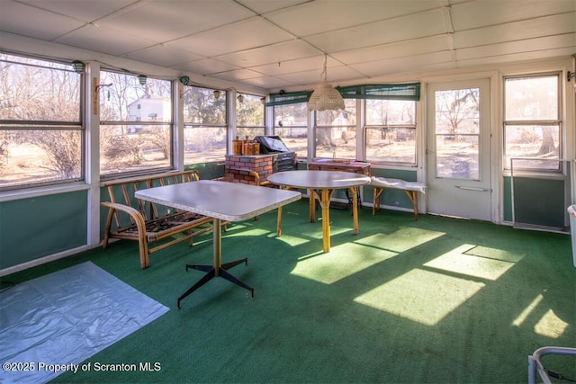 unfurnished sunroom with a paneled ceiling