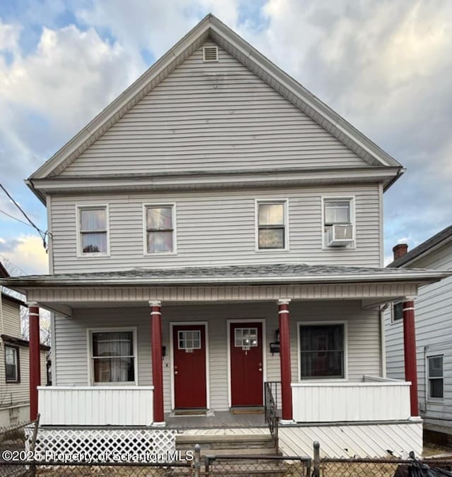 view of front facade with cooling unit, covered porch, and fence private yard