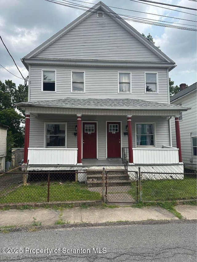 view of front facade with a porch, a gate, and a fenced front yard