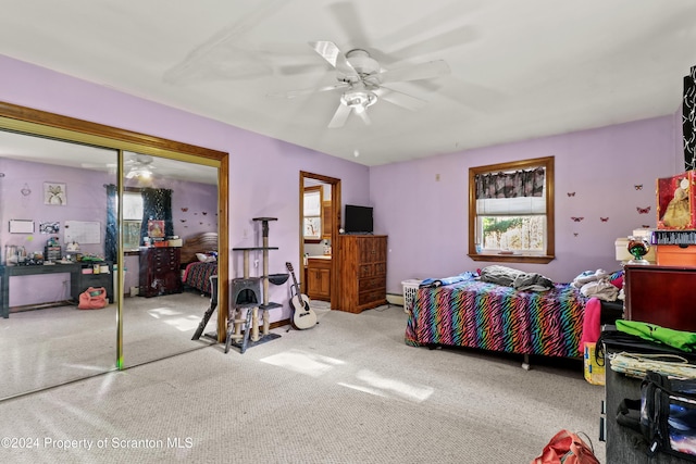 carpeted bedroom with a closet and ceiling fan