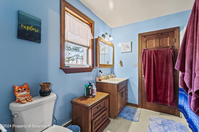 bathroom featuring baseboard heating, vanity, and toilet