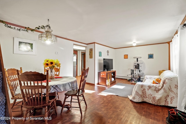 dining area featuring baseboard heating, hardwood / wood-style floors, and ornamental molding