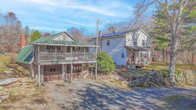 view of front of house featuring a garage and a deck