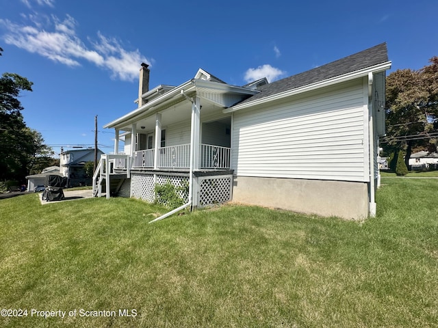 1402 Cherry St, Scranton, PA 18505 - view of side of property featuring a porch, a yard, and a chimney