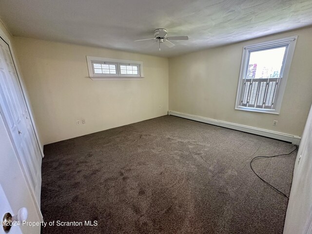 1402 Cherry St, Scranton, PA 18505 - unfurnished bedroom with baseboard heating, multiple windows, and carpet flooring