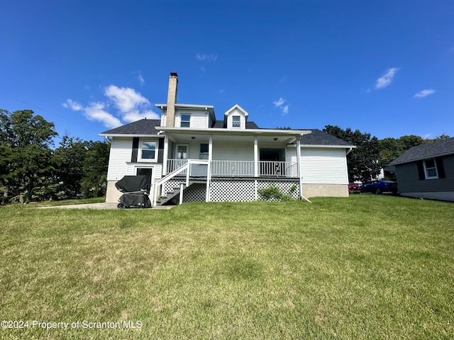 1402 Cherry St, Scranton, PA 18505 - back of house with covered porch, a chimney, and a yard
