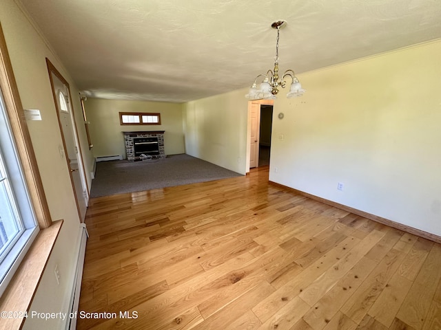1402 Cherry St, Scranton, PA 18505 - unfurnished dining area with a fireplace, light wood finished floors, a chandelier, and baseboard heating