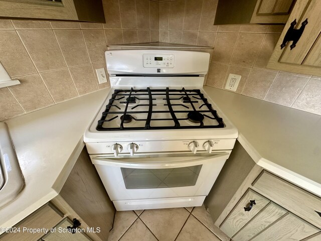 1402 Cherry St, Scranton, PA 18505 - kitchen view of white gas range and decorative backsplash