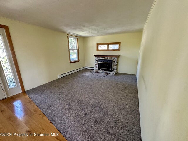 1402 Cherry St, Scranton, PA 18505 - unfurnished living room featuring a baseboard heating unit and a fireplace with raised hearth