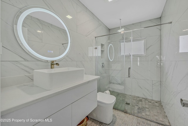 bathroom featuring toilet, vanity, and a stall shower
